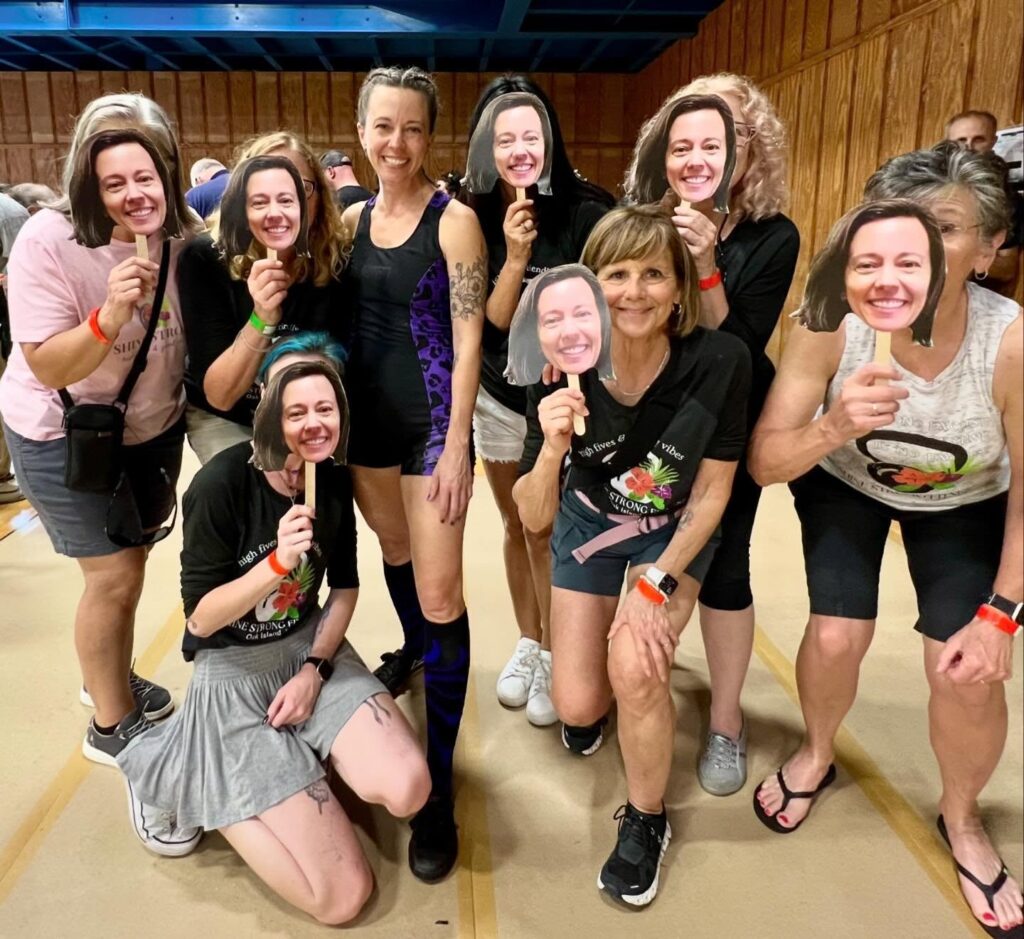 friends cheering me on with my face on popsicle sticks